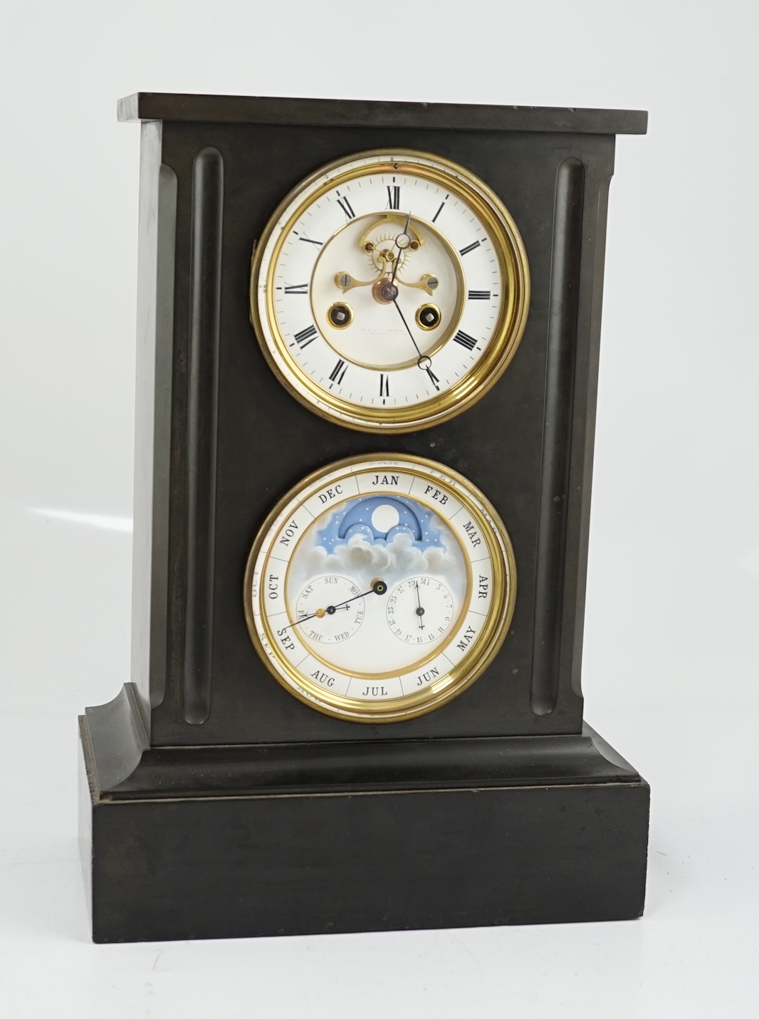 A late 19th century French black slate calendar mantel clock